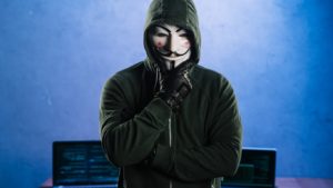 Image of an anonymous person with laptops